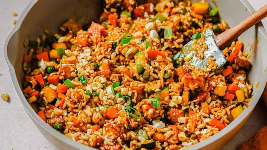 A pan filled with rice and vegetables.