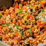 A pan filled with rice and vegetables.