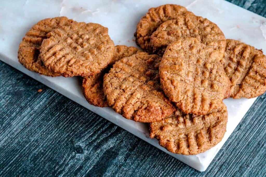 Peanut butter cookies on a marble plate.