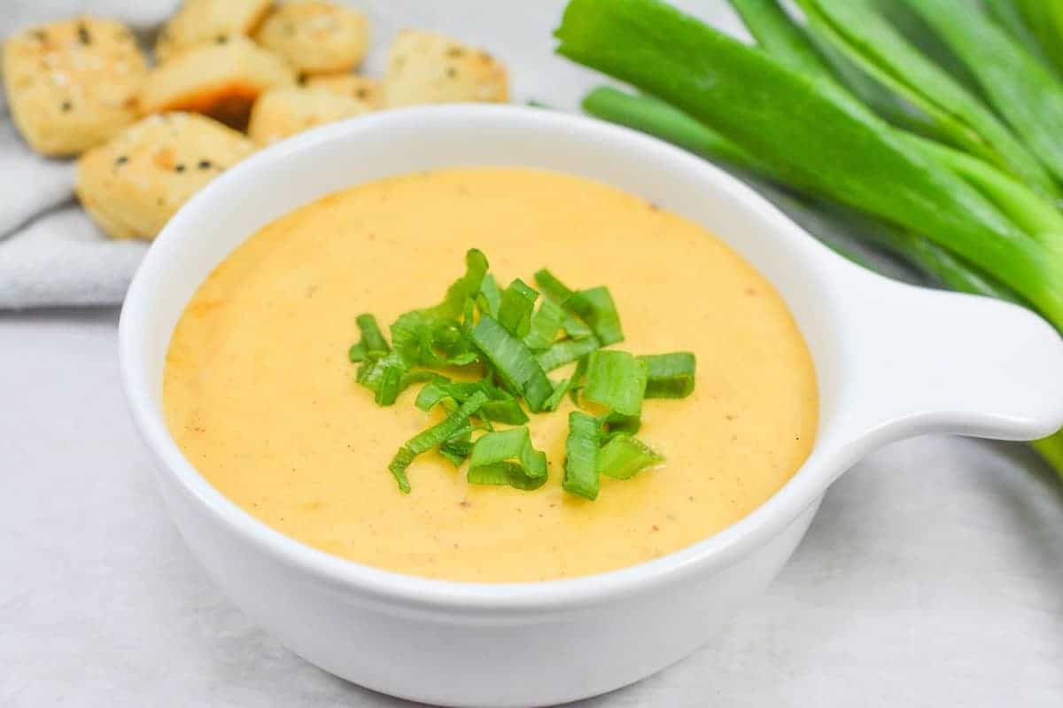 Cheese dip in a white bowl.