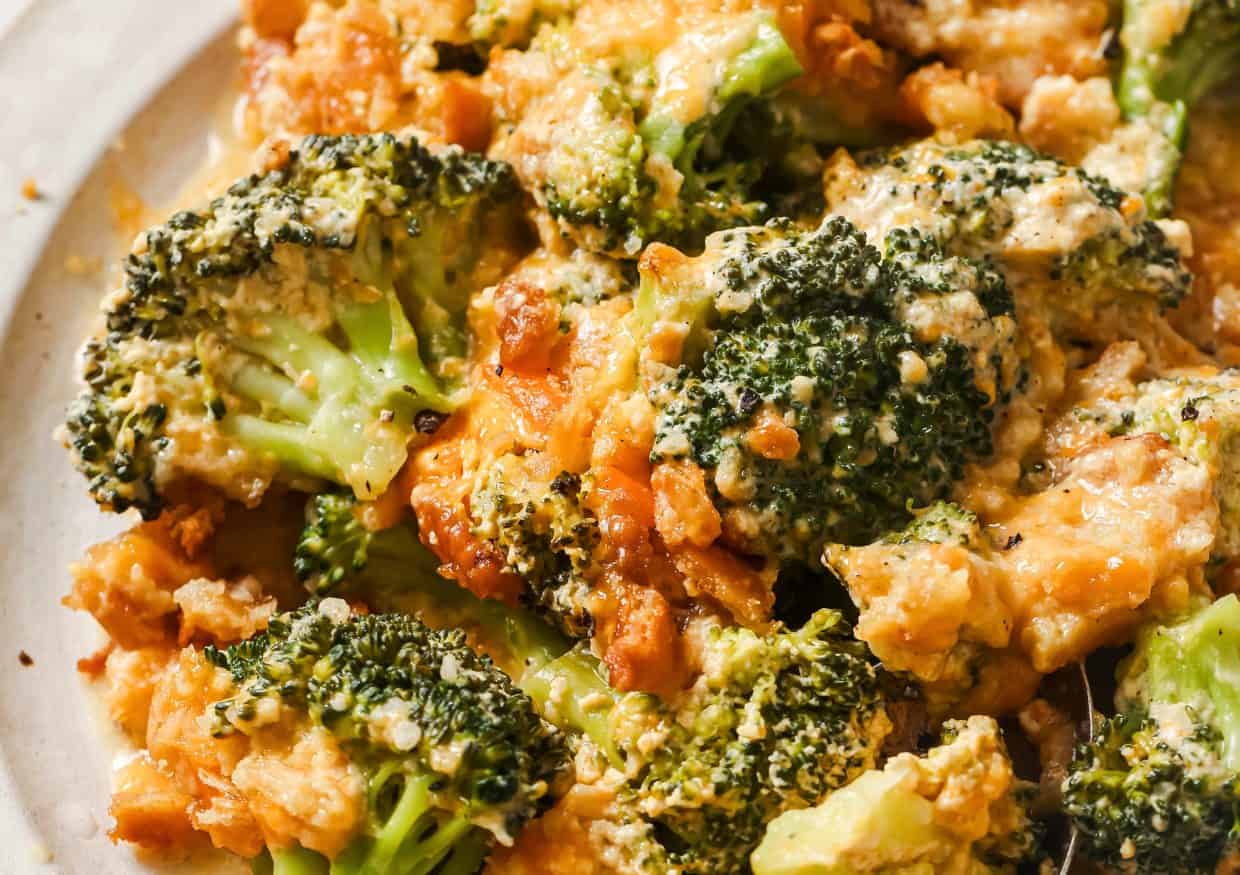 A casserole dish with broccoli and cheese in it.