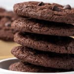 A stack of chocolate chip cookies in a white bowl.