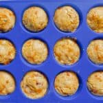 A blue muffin pan filled with breakfast muffins.