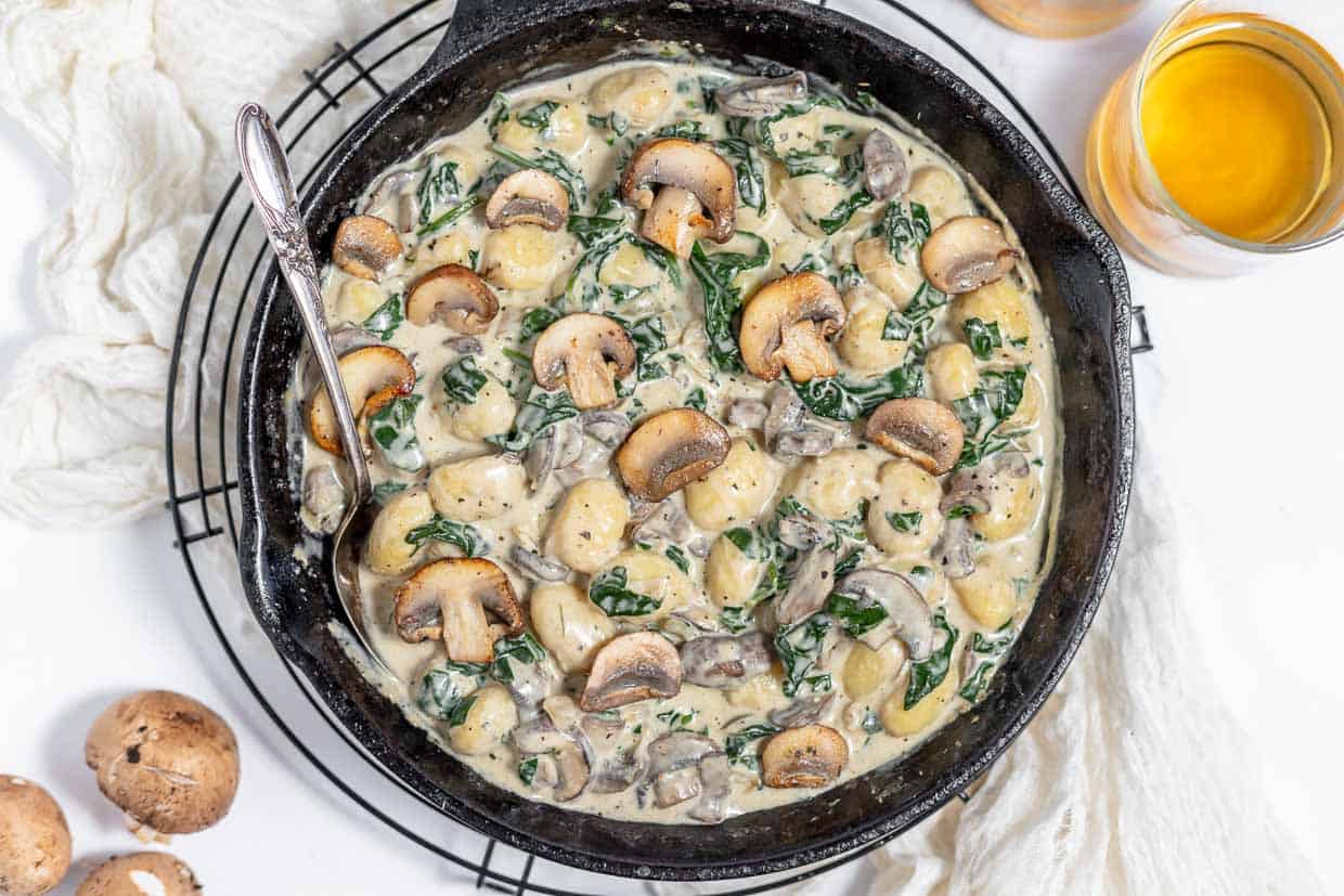 A pan of creamy mushrooms and gnocchi.