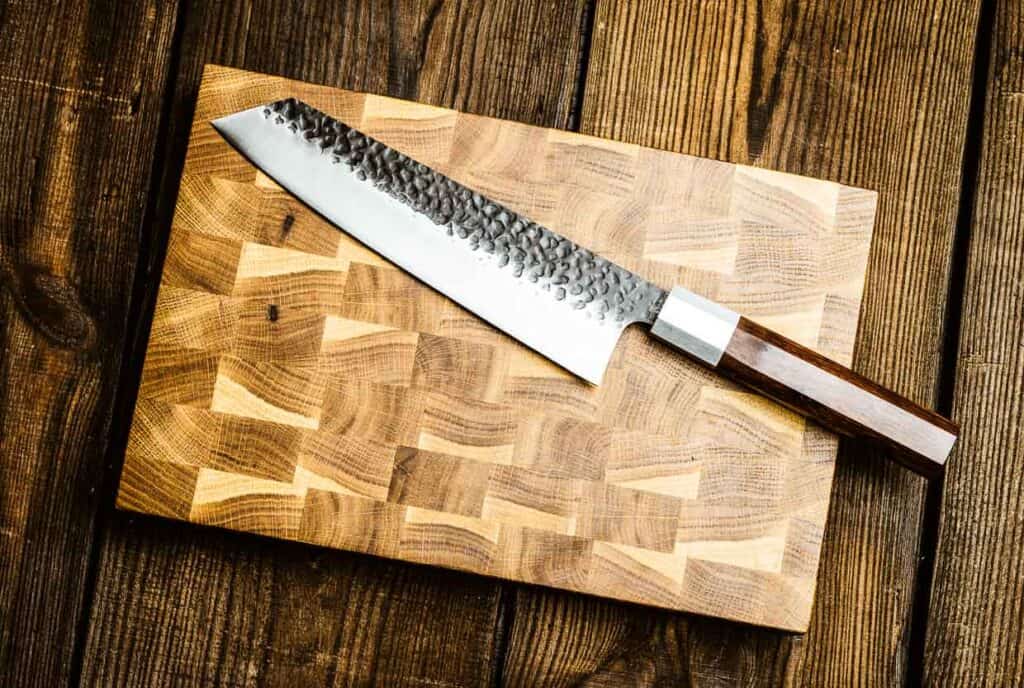 A knife on a wooden cutting board.