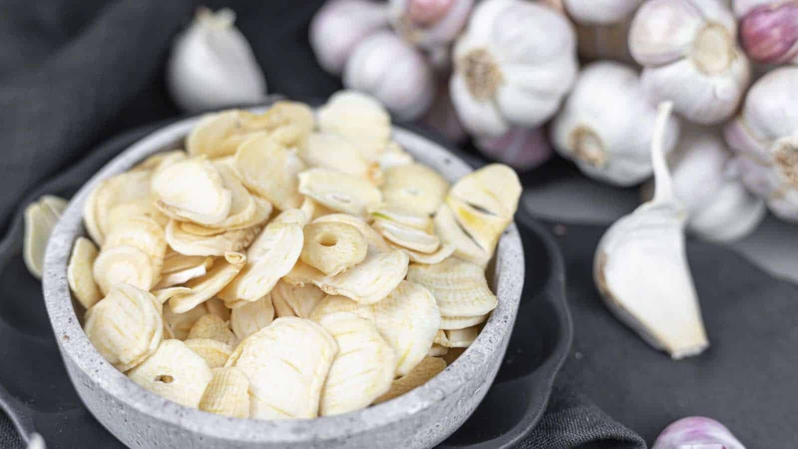 Garlic chips in a bowl on a black background.