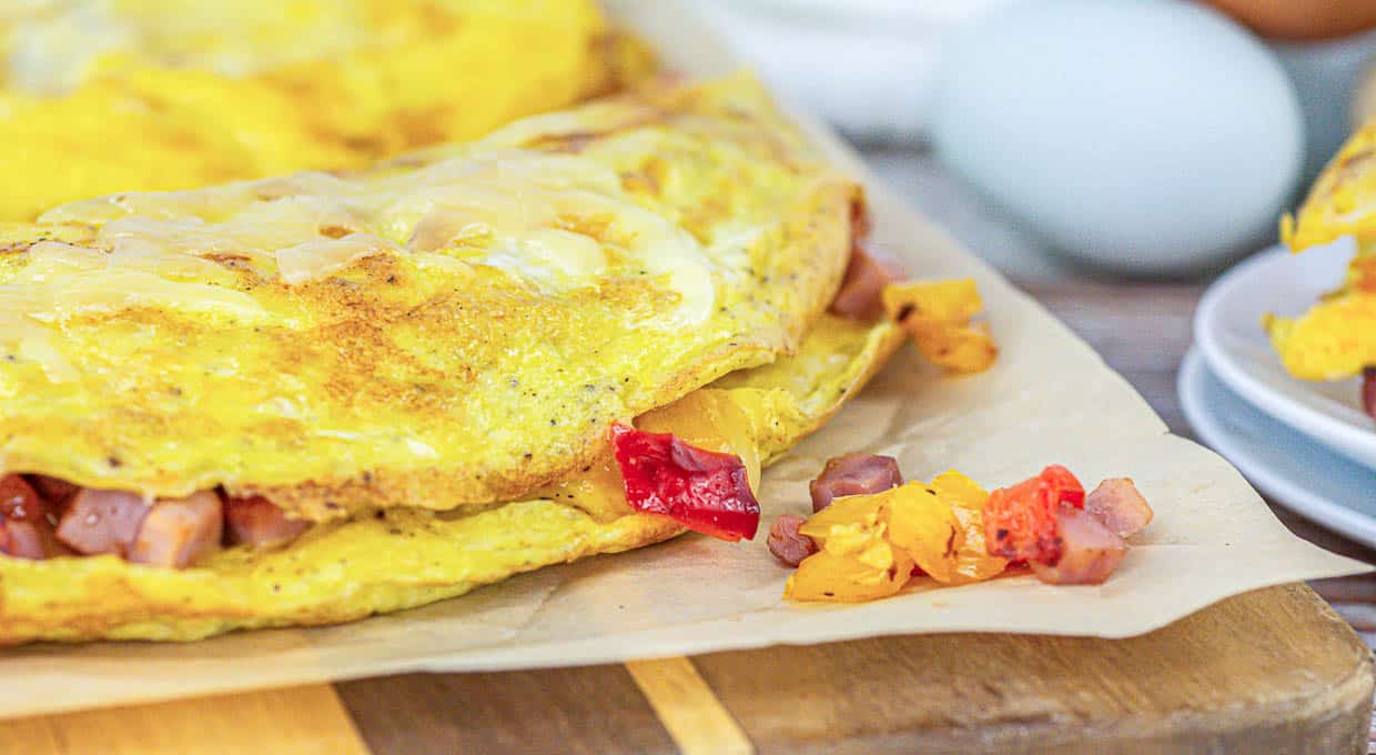 Omelets on a wooden cutting board.