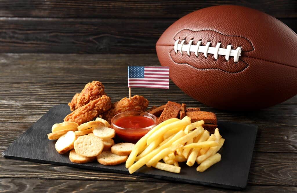 A plate with a football, french fries and an american flag.