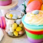 A colorful easter dessert in a cup with eggs and candy.