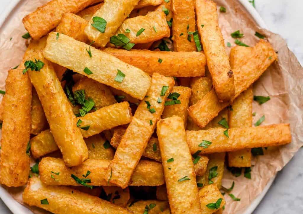 Jicama fries on a plate with parsley.