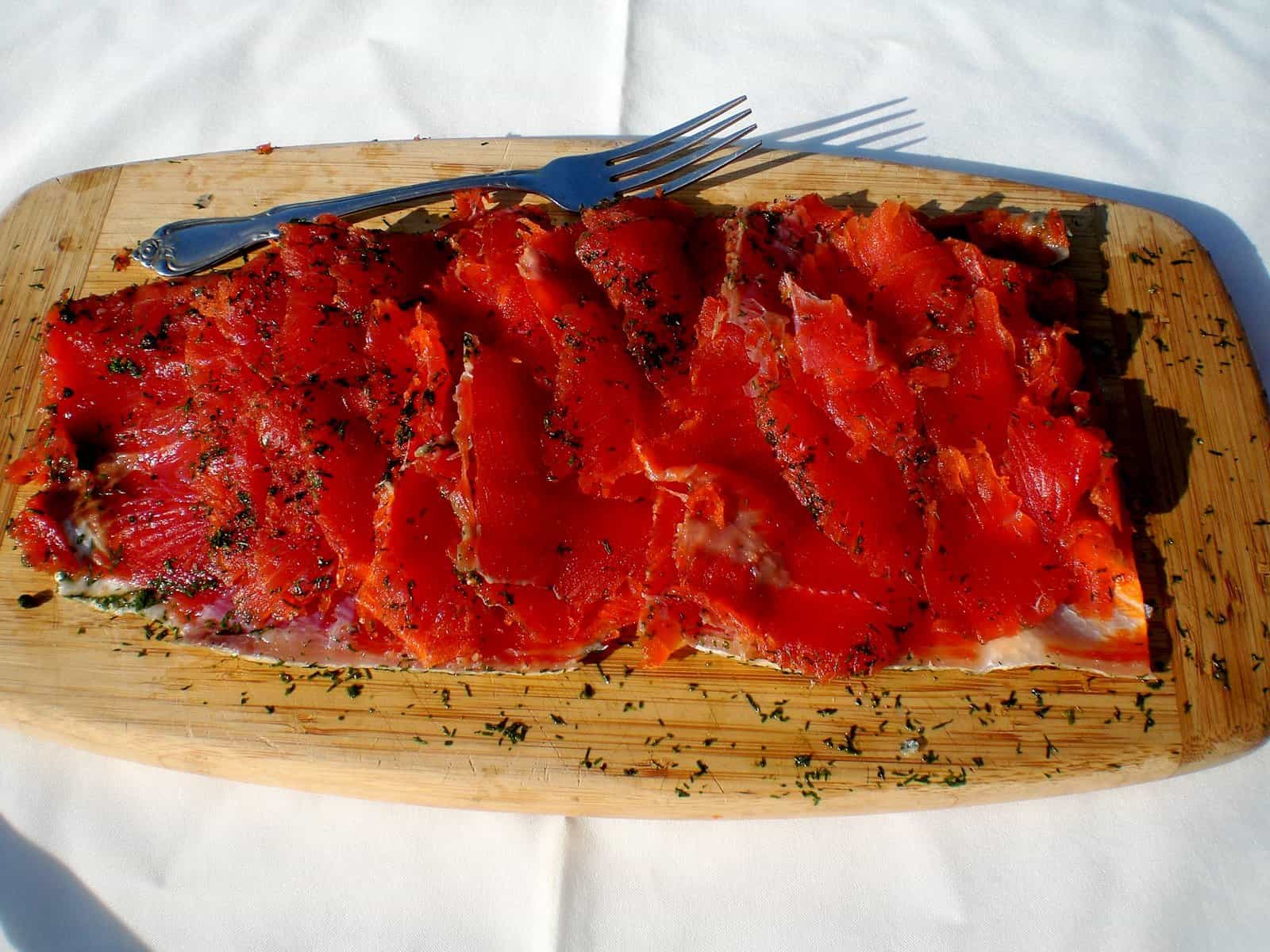 Red salmon on a cutting board.