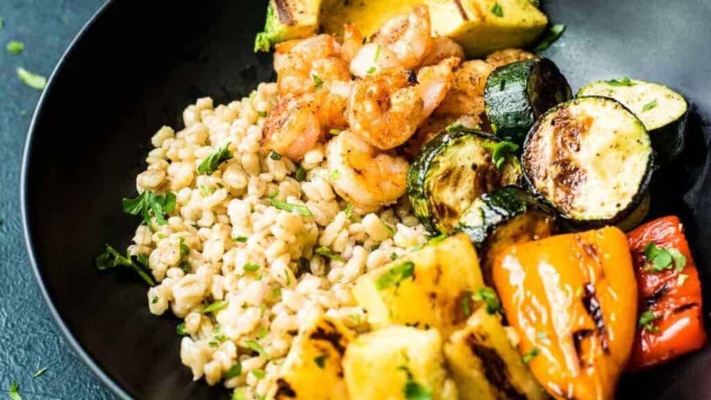 Packed with the fresh flavors of summer grilling and topped with a homemade herb citrus vinaigrette, this grilled shrimp grain bowl is an inspired summer meal you'll be coming back to all season long.