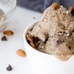 Chocolate almond ice cream in a bowl with almonds.