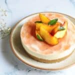 A cheesecake with peaches on top.
