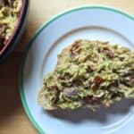 Image shows an overhead shot of an open face Pesto and Sundried Tomato Tuna Salad sandwich.