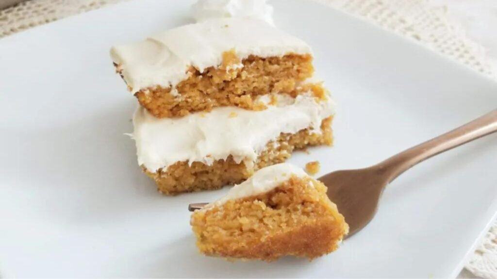 A slice of pumpkin bars on a plate.