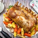 A plate of Pork Roast with Apples on a table.