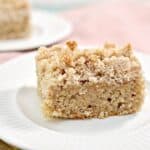 A piece of crumb coffee cake on a plate.