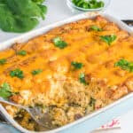 A casserole dish filled with cheese and spinach.