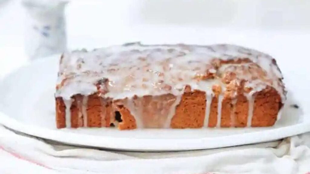 A plate with a loaf of bread decorated with icing, perfect for Valentine's desserts.