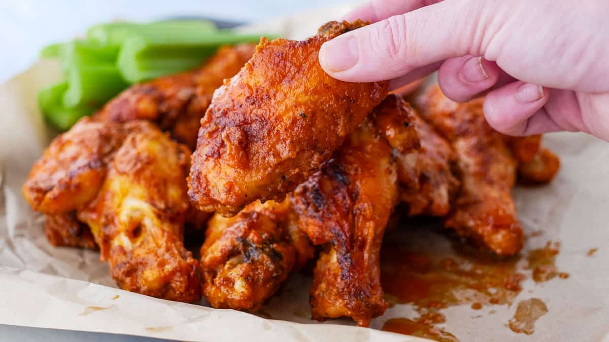 Bbq chicken wings with celery and ketchup.