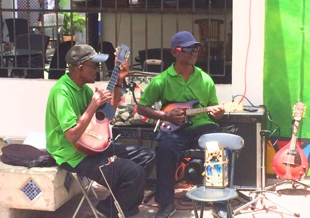 Two men playing instruments outside.