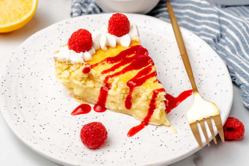 A slice of lemon pie on a plate with a fork.