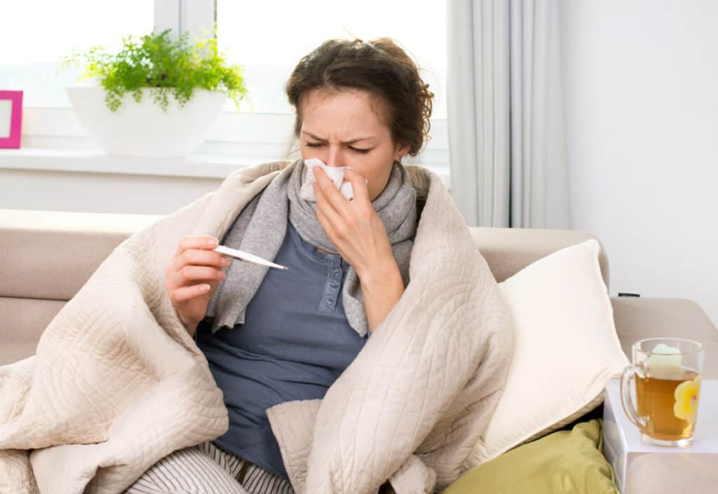 A woman blowing her nose.