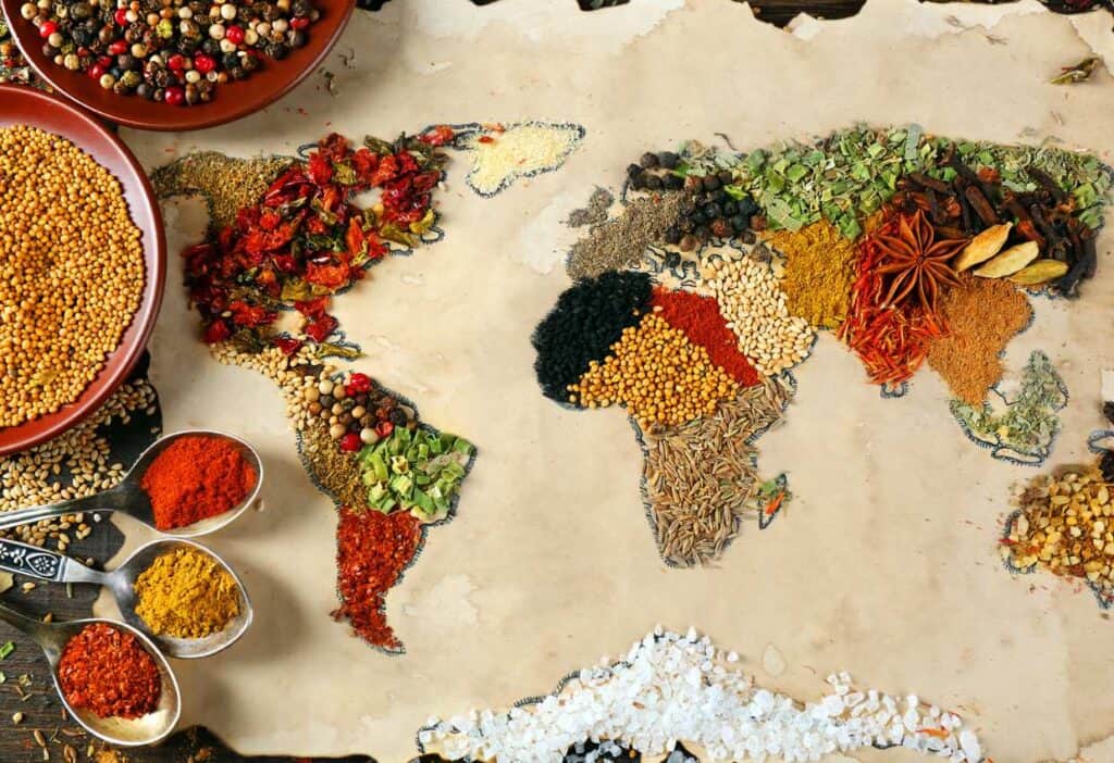 A map of the world highlighting various types of cuisines with spices on it.