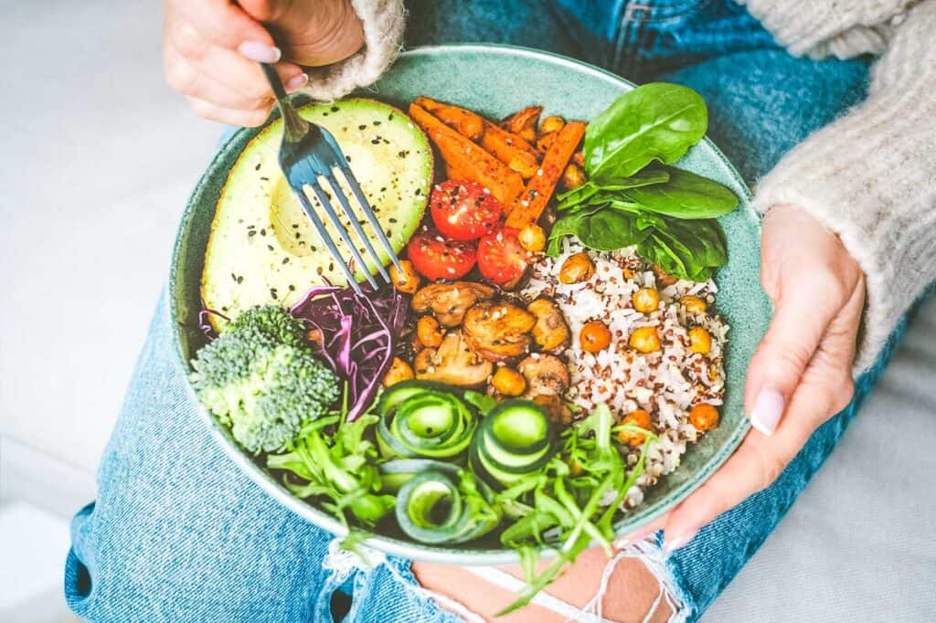 Plate of vegetarian food on a lap.