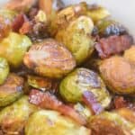 Roasted brussels sprouts with caramelized edges in a serving dish.