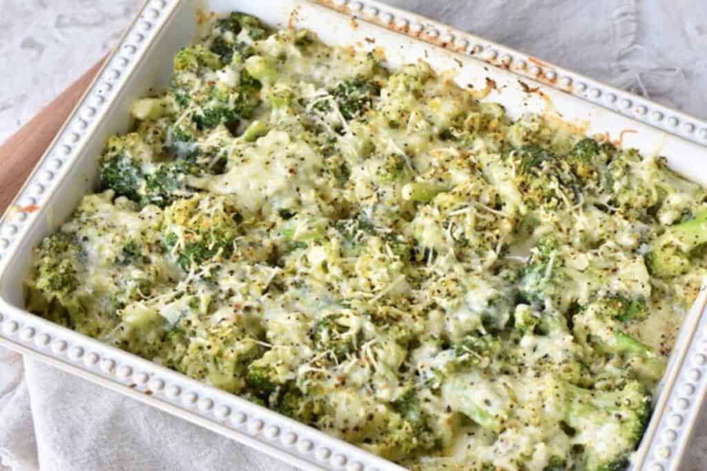 Baked broccoli and cheese casserole in a white dish.