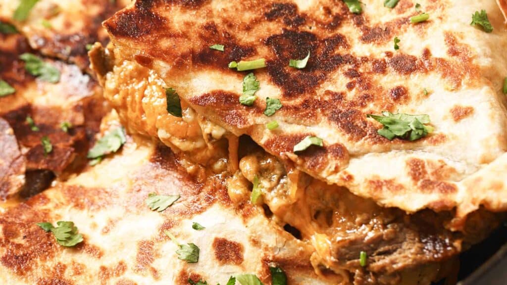 Quesadillas with meat and cheese on a plate.