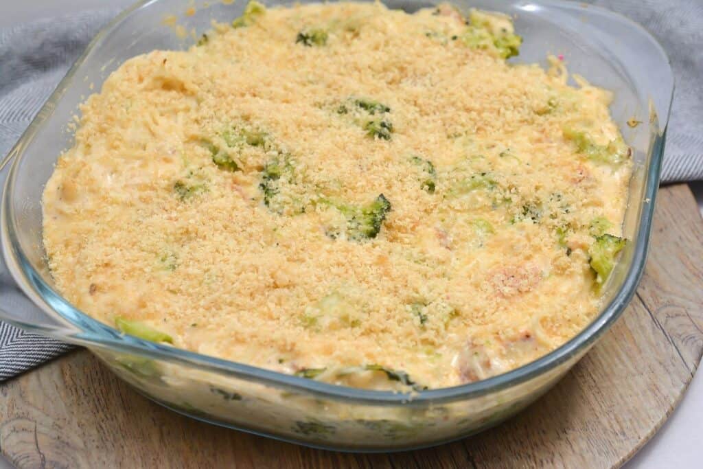 A freshly baked broccoli casserole in a glass dish, topped with golden breadcrumbs.