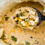 A bowl of mexican chicken chowder with corn and black beans.