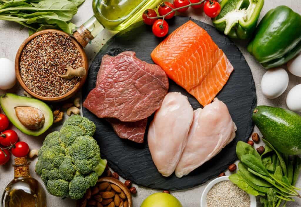 Assorted healthy foods debunking nutrition myths, including vegetables, lean meats, nuts, and grains arranged on a table.