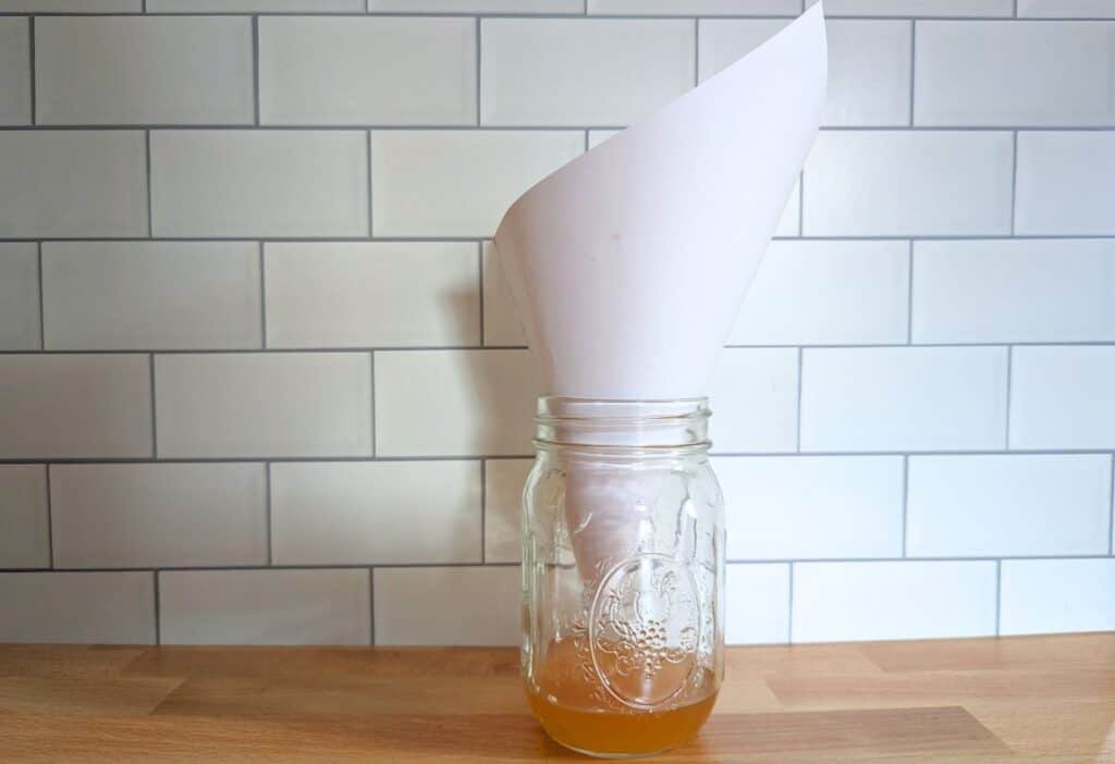 A mason jar with a piece of paper in it.