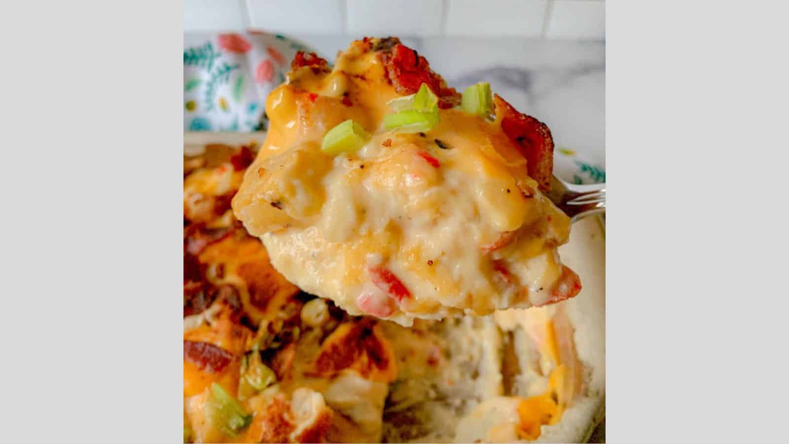 A serving spoon hovering above a casserole with a helping of German potatoes.