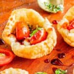 Fresh tomato and herb salad served in puffed pastry cups.