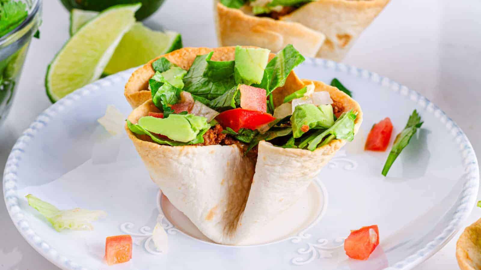 Mexican taco salad cups on a plate.