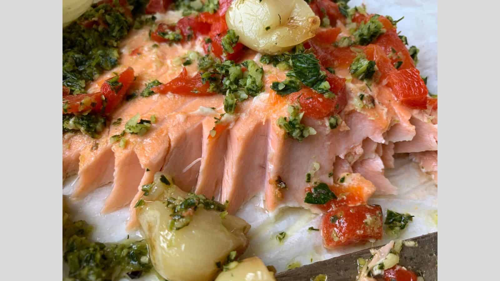 Salmon roasted with herbs, onions, and garlic.