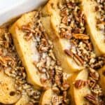 French toast casserole with pecans in a baking dish.