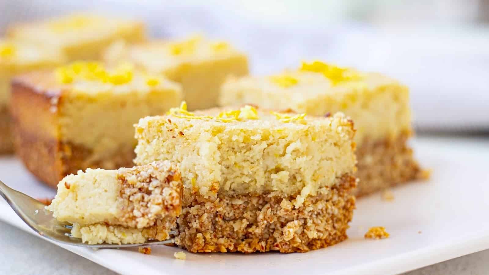 Protein lemon bars bites on a plate with a fork.