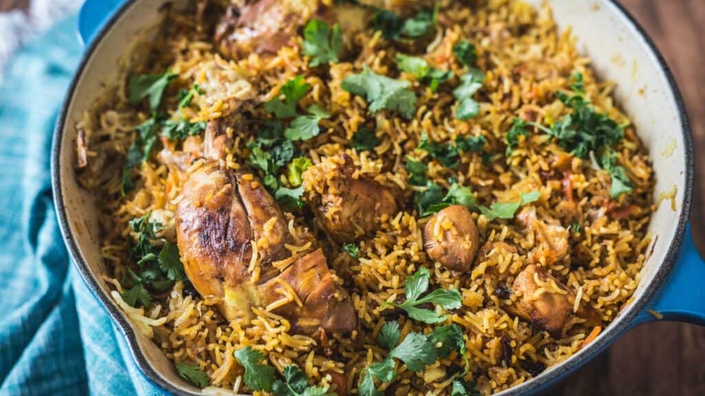 Chicken plov on a plate with a fork.
