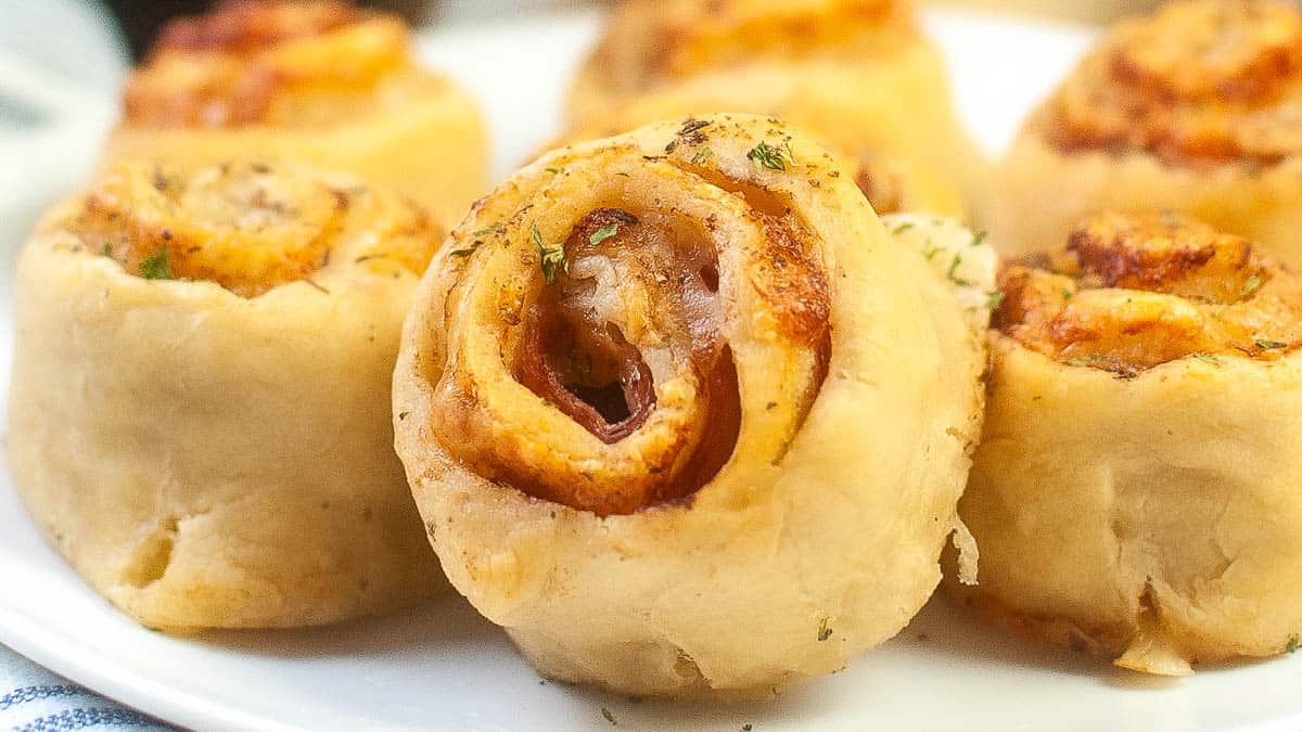 Plate of ham and cheese pizza rolls.