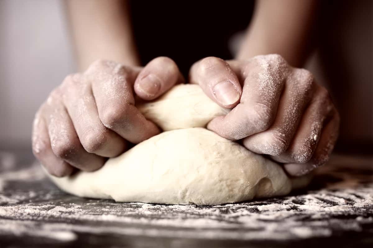 Kneading dough on a floured surface.