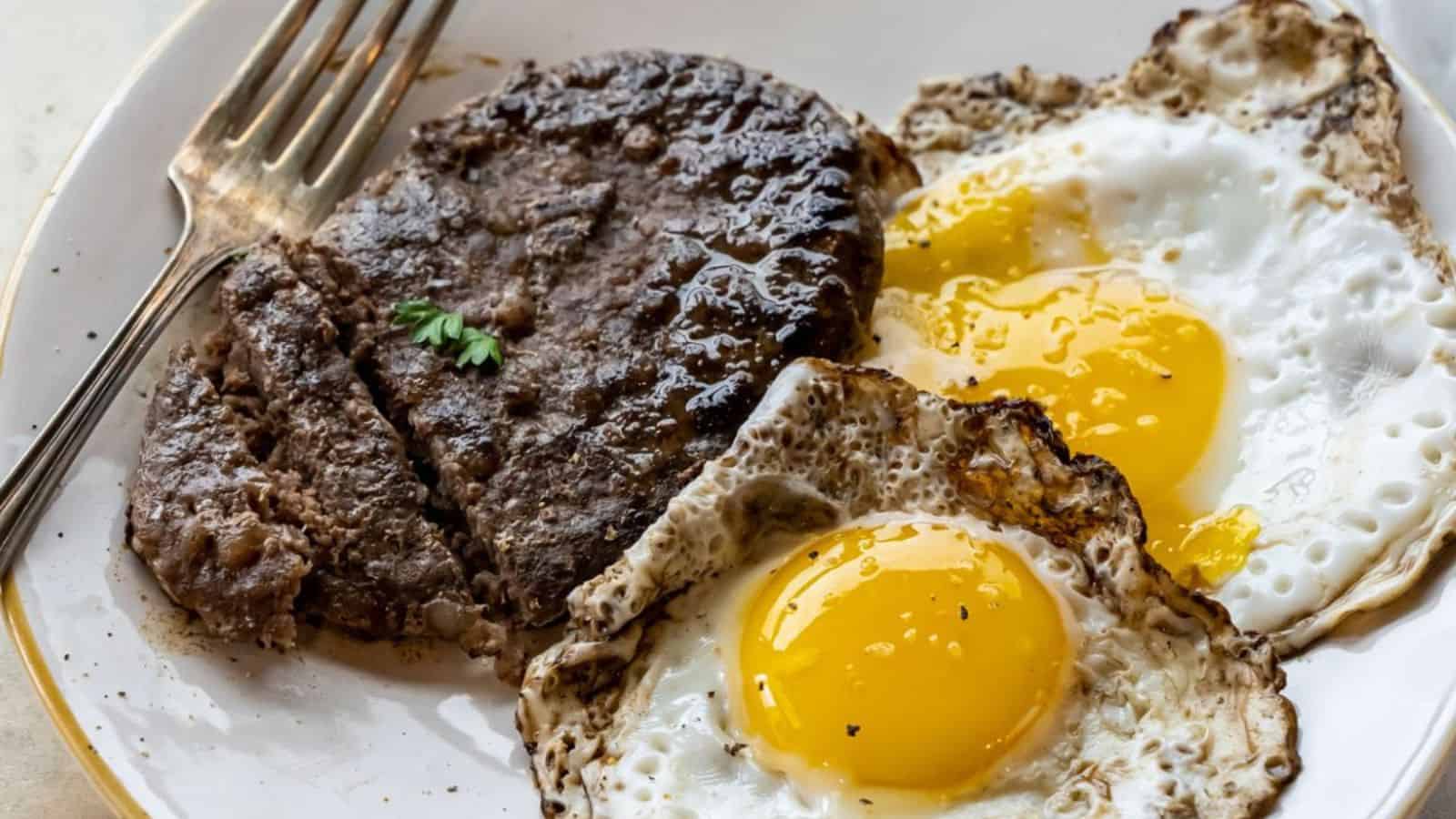 Sausage patty and fried egg cooked on the Blackstone griddle for breakfast.