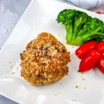 Copycat HelloFresh Crispy Shallot Croquettes on a white plate with tomatoes and broccoli.