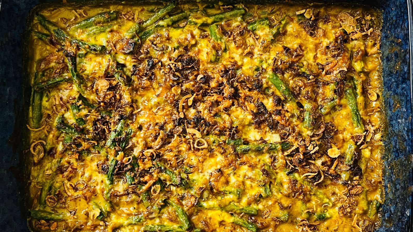 Baked casserole with green beans and crispy fried onions on top.