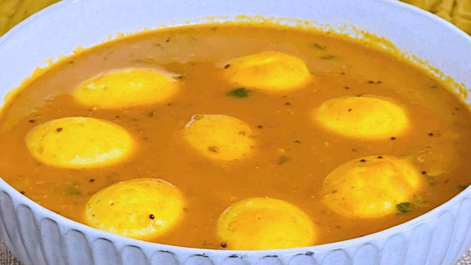 Bowl of indian Egg Curry with visible herbs, reflecting a vibrant, spicy dish.